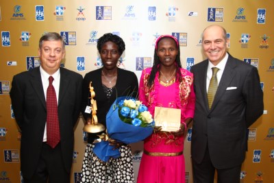 L to R: President of SEGAS Kostas Panagopoulos, BMR women's winner Edna Kiplagat, runner-up Priscah Jeptoo and Vice-Chairman of OPAP SA, AIMS' Patron, Mr. Spyros Fokas.